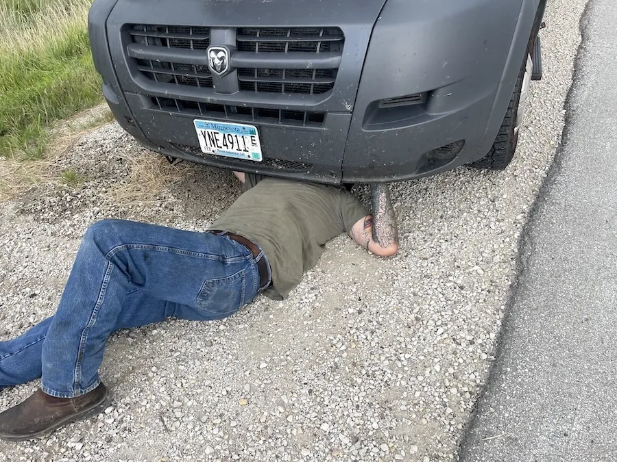 Picture of Zach doing work under van